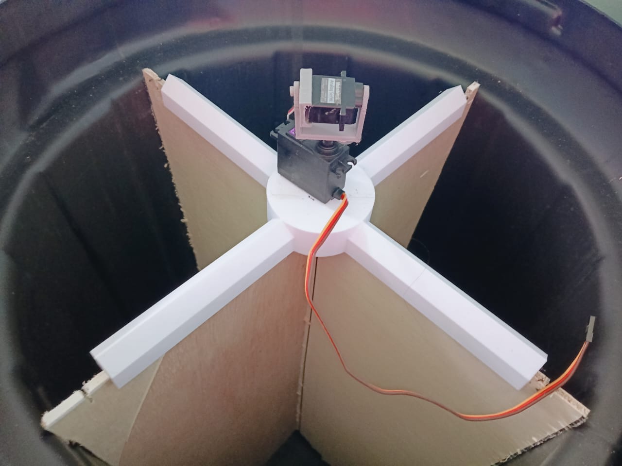 Inside the AiBin showing the 3D-printed cross-divider and servo motor